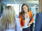 Businesswoman shakes hands with a colleague