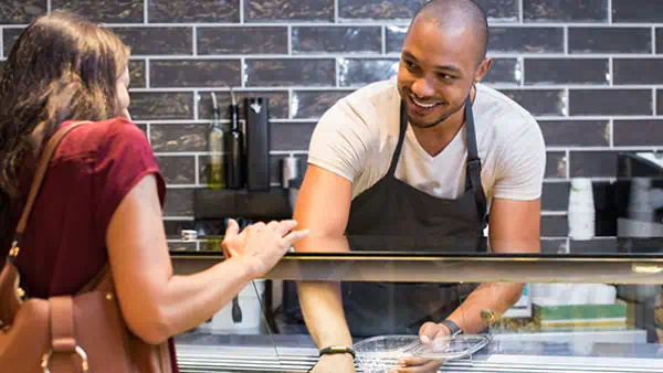 Food service worker serves a customer