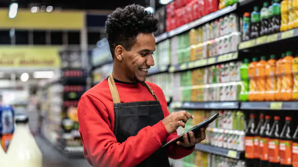 Grocery store employee checking prices