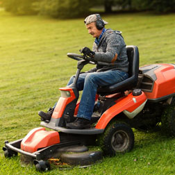 Landscaper mowing grass